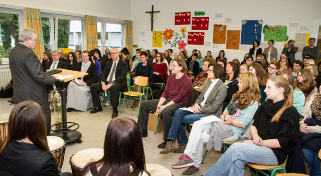 Schulleiter Willi Kruse begrüßt die Schüler und die Lehrer zu der Verlehung der Urkunde in der Musikaula. Foto: SMMP/Bock